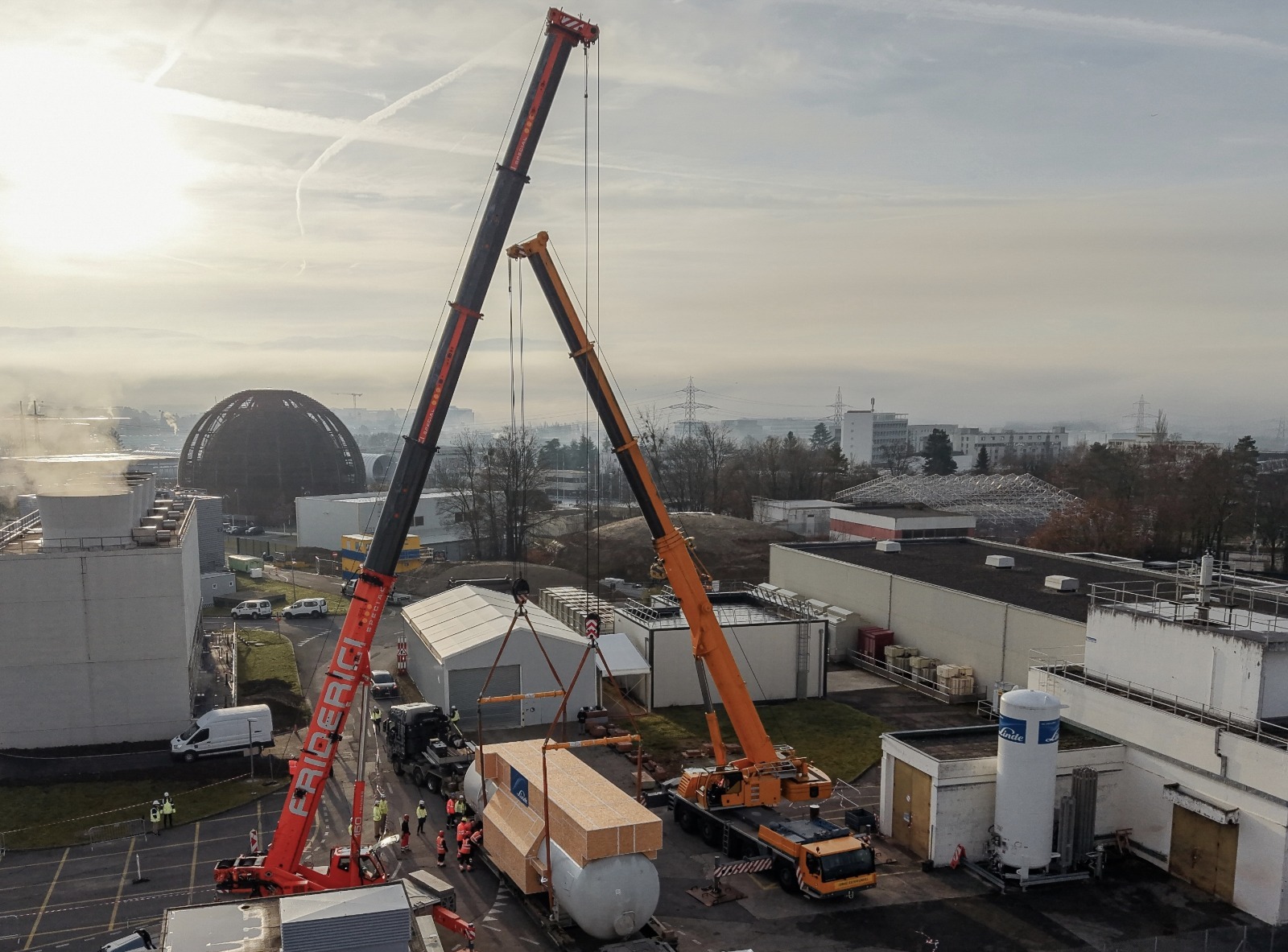 Engineers at CERN install a giant cylindrical cold box for the High-Luminosity LHC cryogenic system.