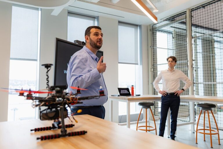 A conceptual illustration of quantum entanglement linking two drones in a disaster zone for secure, signal-free communication.