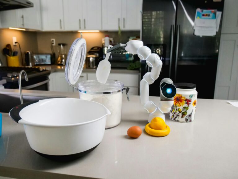 The LG CLOiD home assistant robot with two articulated arms in a modern kitchen setting, as unveiled for CES 2026.