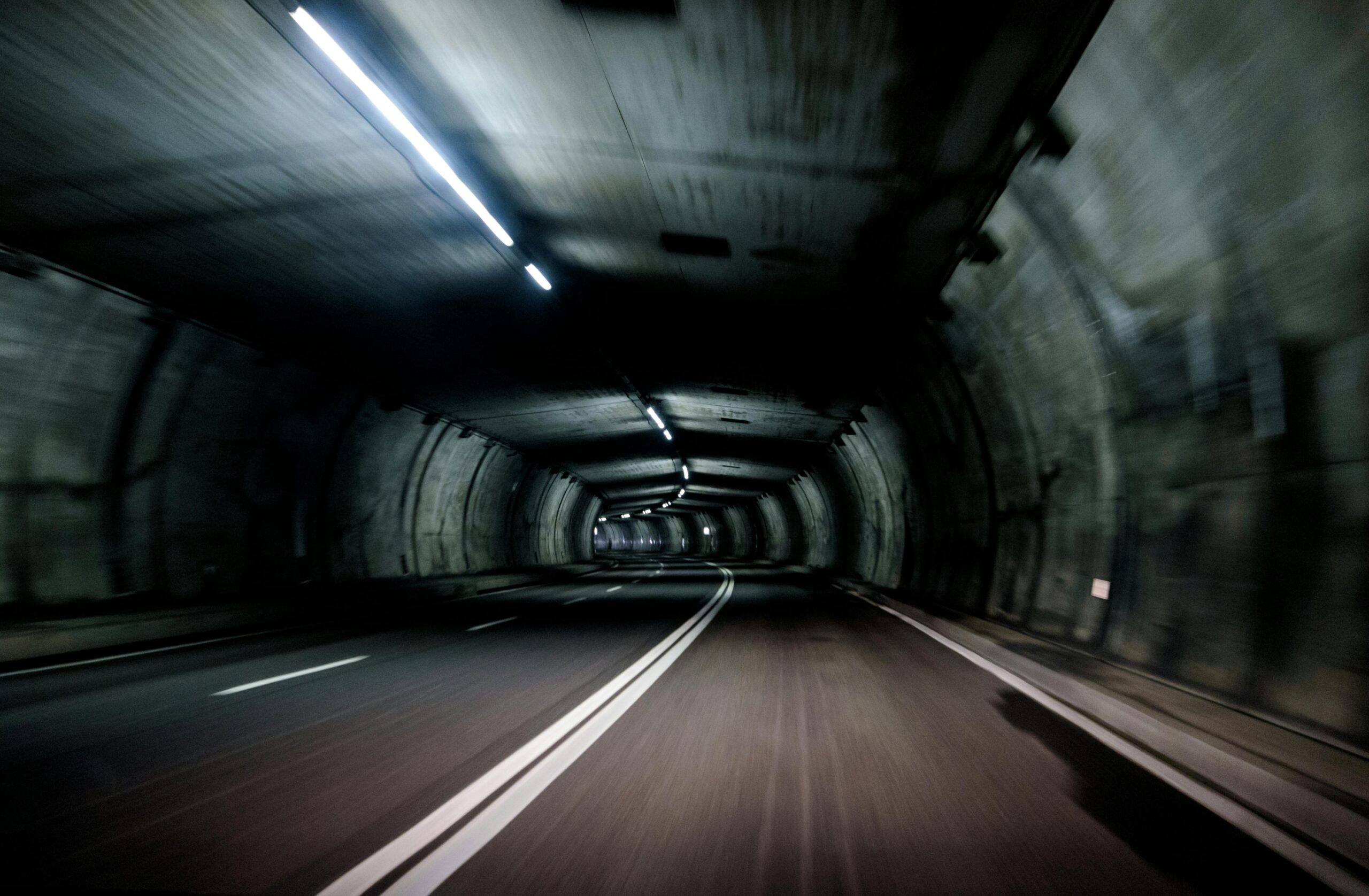 The illuminated entrance of the Tianshan Shengli Tunnel, the world's longest expressway tunnel, cutting through the Xinjiang mountains.