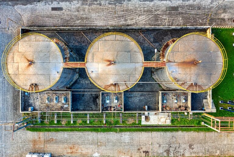 Aerial view of the world's largest liquid-air energy storage plant with rows of white tanks in China's Gobi Desert.