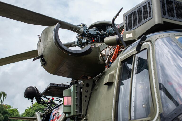 A helicopter rotor hub with four blades, covered in sensor cabling, during a wind tunnel test for the DLR-led active twist rotor project.