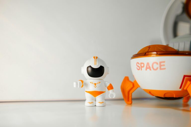 A NASA astronaut works with cube-shaped Astrobee robotic assistants inside the International Space Station's Kibo laboratory module.