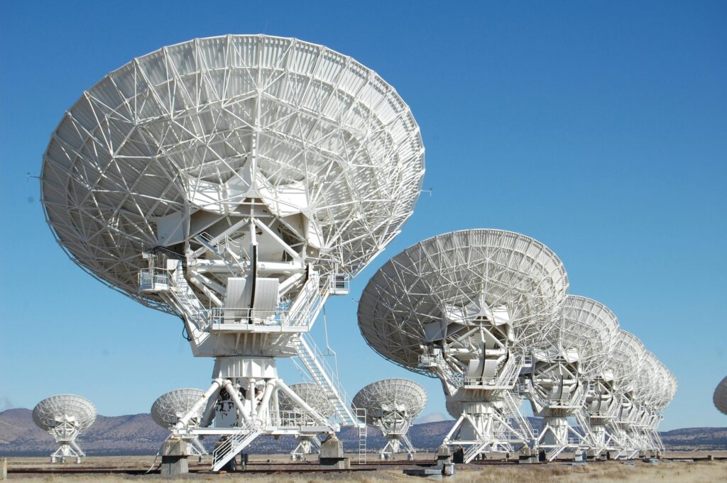 MeerKAT radio telescope discovery of gigamaser from distant galaxy merger with gravitational lensing