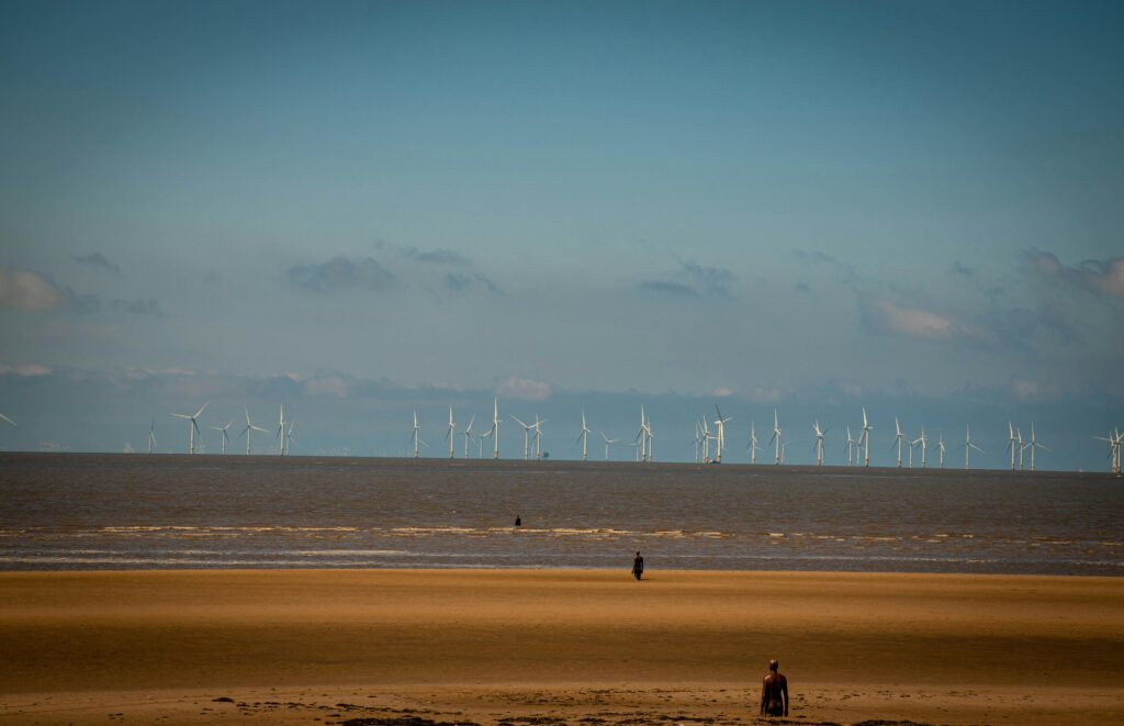 Aerial visualization of Inyanga Marine Energy Group's HydroWing tidal energy project at Morlais, Wales, featuring multiple underwater turbines generating renewable electricity from tidal currents.