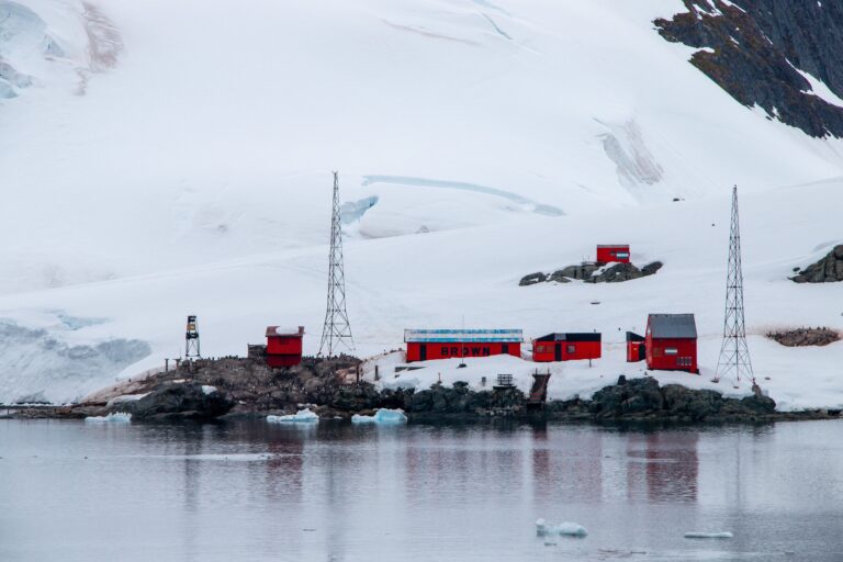 China's Qinling Antarctic research station with renewable energy equipment in a snowy Antarctic landscape.