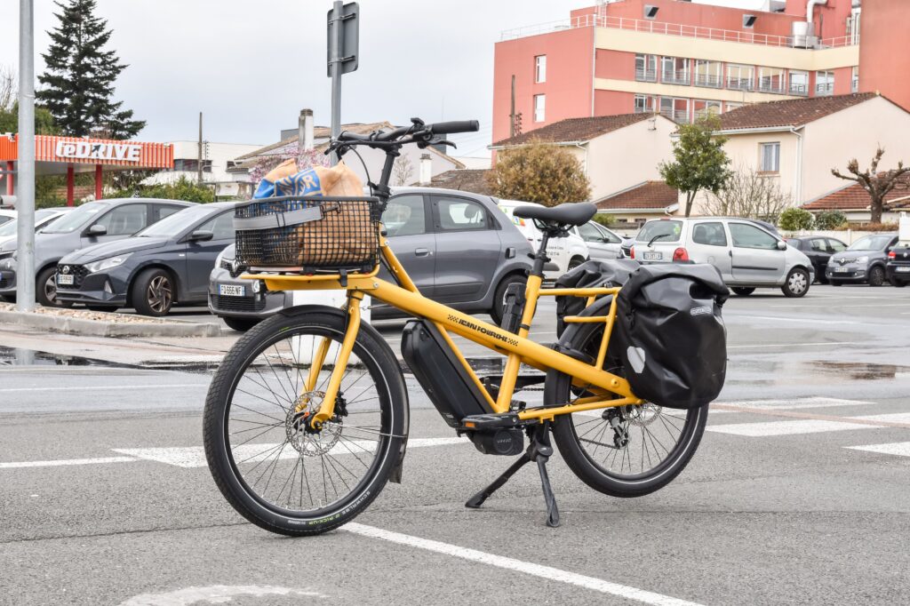 A Lectric electric bicycle parked on a city street during daylight.
